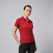 Women's Smash Polo - A red women's polo shirt featuring a collar and a branded logo.