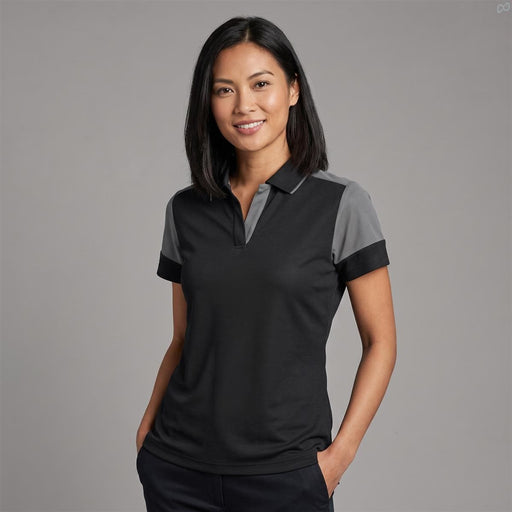 Women's Printer Prime Polo - A woman models a women's polo shirt in black with grey accents, featuring a collar and short sleeves.