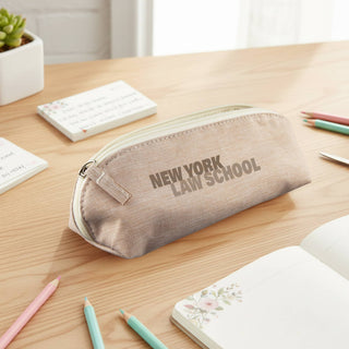 Penca RPET Pencil Case - A beige pencil case with a zip closure sits on a wooden desk among stationery and notepads. It features a logo.