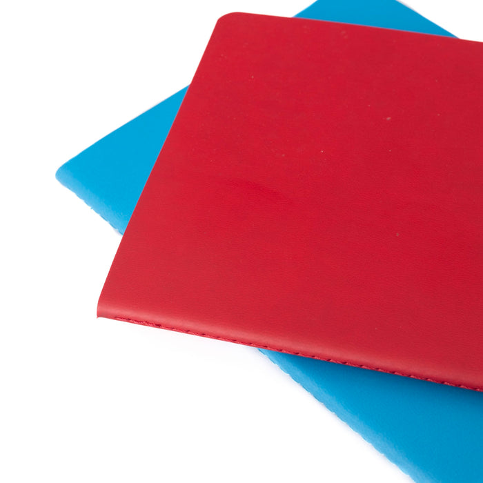 A5 Thin PU Cover Notebook - A5 thin PU cover notebook with a red exterior, placed over a blue notebook. Both have a smooth finish and a logo.