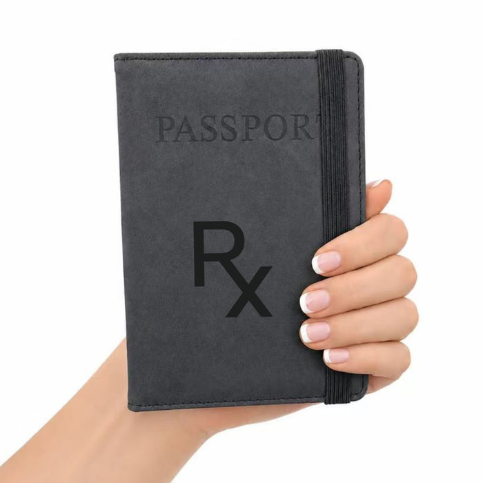 Traveller Passport Wallet - A grey passport wallet is held in a hand, featuring a band for secure closure and a logo on the cover.