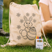 Squiggle Calico Drawstring Bag + Crayon set - A cream drawstring bag featuring a bunny and floral design, accompanied by a crayon set in various colours.