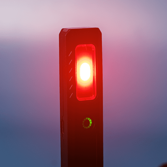 Rechargeable Work Light - A rechargeable work light with a red light and a green indicator, featuring a sleek black design and a logo.