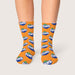 Magic Dress Socks - Bright orange socks with repeated Fanta branding, featuring a logo and green leaf design.