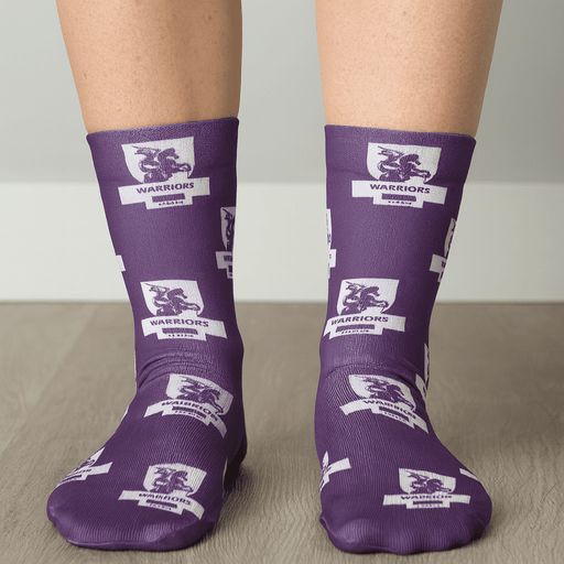 Magic Dress Socks - Purple socks featuring a pattern with lions and logos, showcasing a vibrant design and comfortable fit.