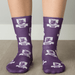Magic Dress Socks - Purple socks featuring a pattern with lions and logos, showcasing a vibrant design and comfortable fit.