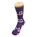 Magic Dress Socks - A purple sock featuring a pattern with a logo and text, displayed on a sock model.