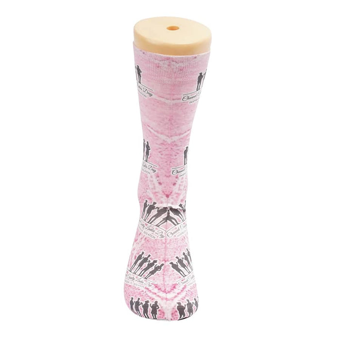 Magic Dress Socks - A pair of pink dress socks featuring a repeated pattern and a display stand with a logo.