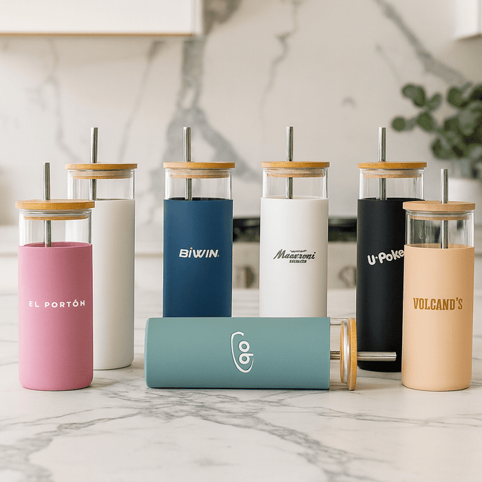 Sunrise Smoothie 500mL Tumbler - A collection of colourful plastic tumblers with bamboo lids and straws in various shades, featuring different logos.