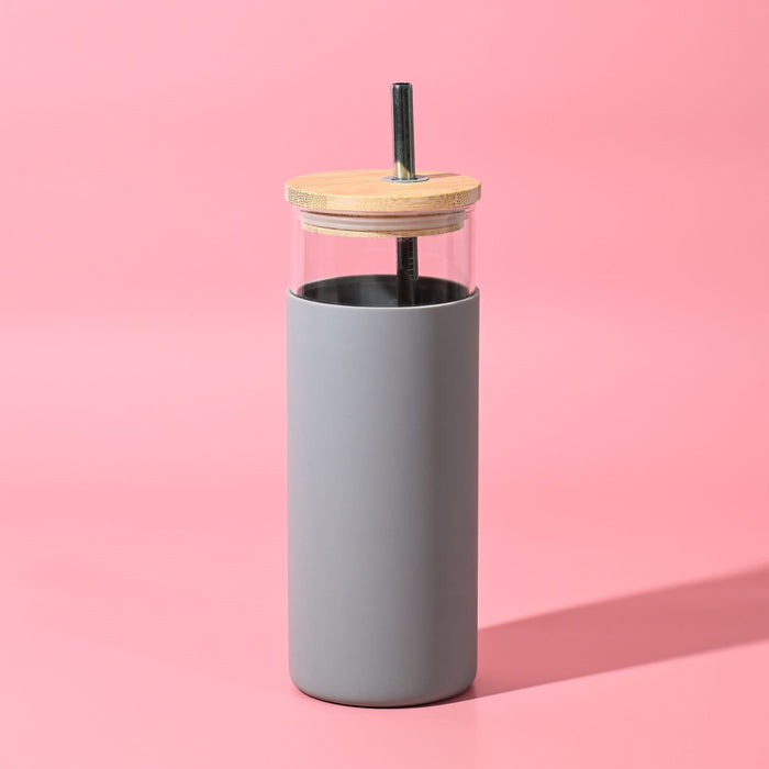 Sunrise Smoothie 500mL Tumbler - A drink bottle with a grey silicone sleeve, clear glass body, and wooden lid, featuring a reusable straw.