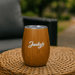 Ecograin Mirror Finish 230mL Calm Cup - A drink bottle in a wood grain finish with a clear lid and a logo on the side, placed on a woven surface.