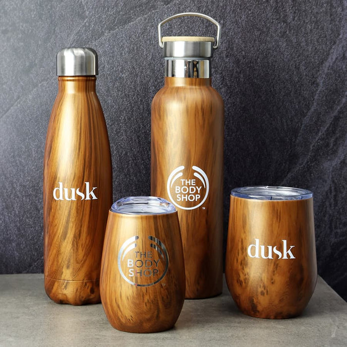 Ecograin Mirror Finish 230mL Calm Cup - A drink bottle and assorted drinkware in a wood-like finish, featuring silver accents and branding logos.