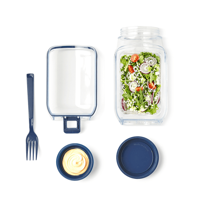 Go Salad Jar - A salad jar with a blue lid, containing salad, a fork, and a separate container with dressing.