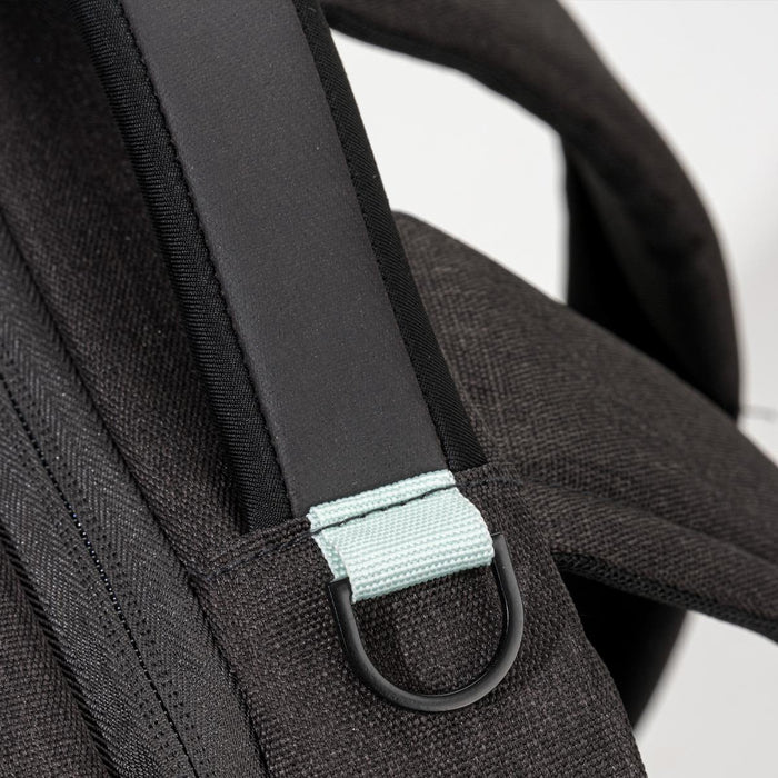 Swissdigital Arosa Backpack - A black backpack strap featuring a light blue accent and a metal loop. The material has a textured finish.