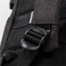 Swissdigital Arosa Backpack - A close-up of a black backpack strap buckle with textured fabric in the background. The backpack has a logo.