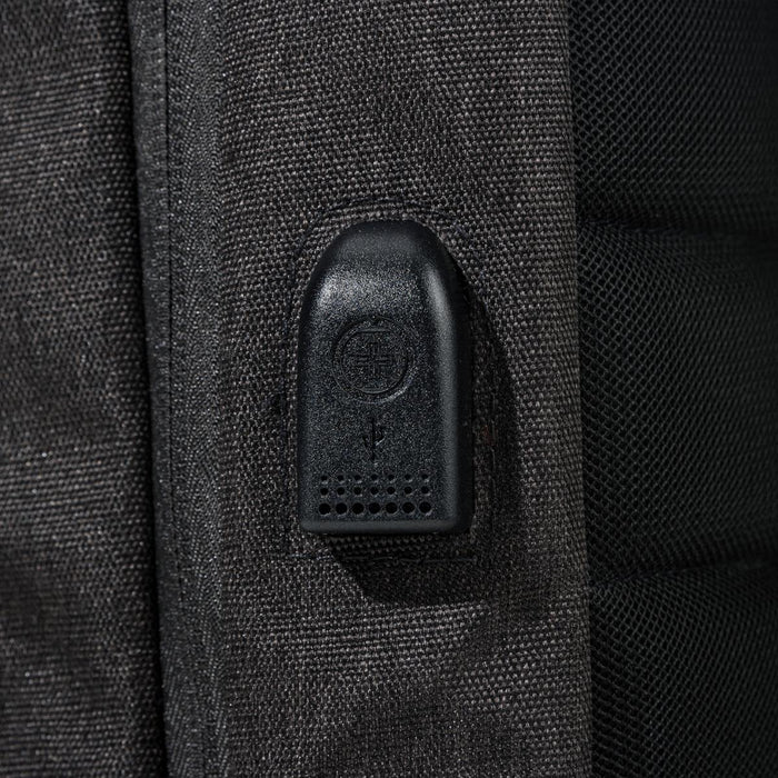 Swissdigital Arosa Backpack - A close-up of a feature on a black backpack, showcasing a zipper pull and textured fabric.