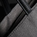Swissdigital Arosa Tote Bag - A grey tote bag featuring dark green leather handles and stitching, with a close-up view of the fabric texture.