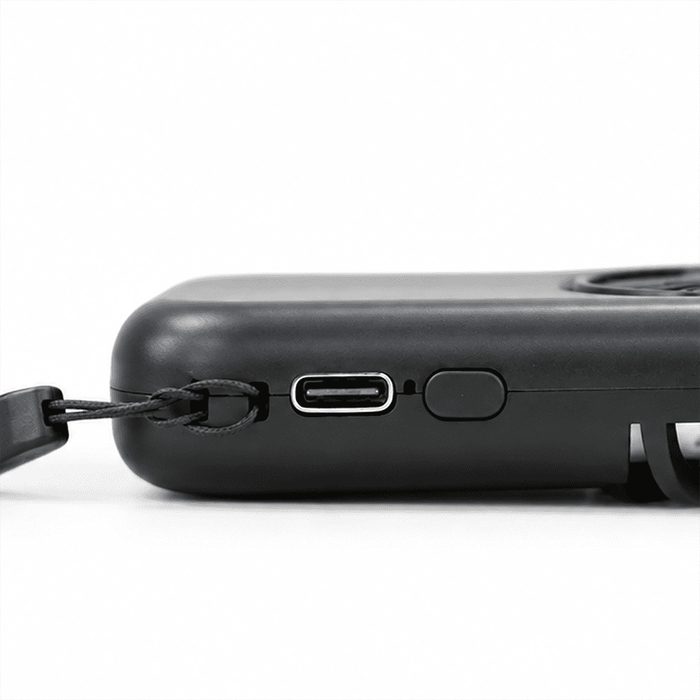Mini Pocket Fan - A black mini pocket fan with a USB-C charging port and a strap attachment for easy carrying.
