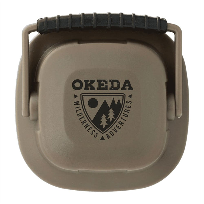 Mini Camping Lantern - A compact, khaki-coloured mini camping lantern with a handle and a logo on the front.