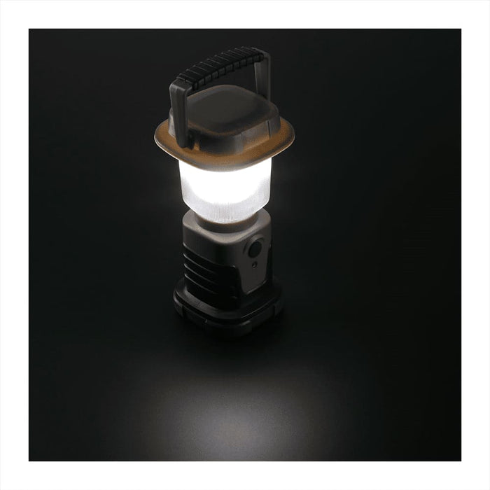 Mini Camping Lantern - A mini camping lantern in grey and black with a transparent light dome and a handle on top.