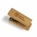 Bamboo Stapler - A bamboo stapler with a wooden finish and a silver stapling mechanism, featuring a logo on the surface.