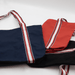 Century Canvas Tote Bag - A navy, red, and black canvas tote bag with striped handles, featuring a logo on one side.