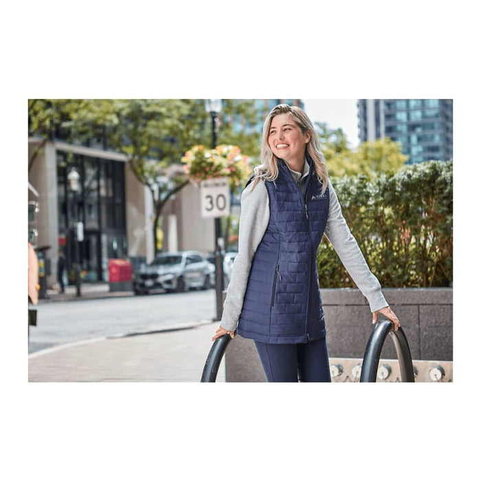 Women's Telluride Lightweight Packable Insulated Puffer Vest - A lightweight, insulated puffer vest in navy, featuring a grey hood, displayed on a woman outdoors.