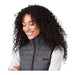 Women's Telluride Lightweight Packable Insulated Puffer Vest - A grey lightweight packable insulated puffer vest with a black collar and a logo on the front, worn by a smiling woman.
