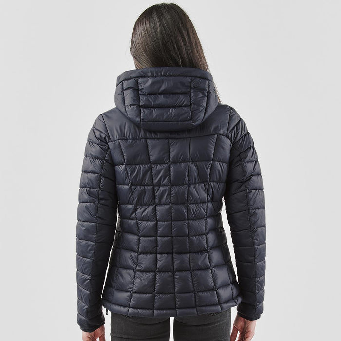 Women's Tundra Thermal Jacket - A women's puffer jacket in navy blue with a quilted design and a hood, viewed from the back.