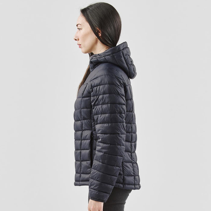 Women's Tundra Thermal Jacket - A side view of a women's puffer jacket in navy blue, featuring a hood and horizontal quilted design.