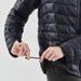 Women's Tundra Thermal Jacket - A black women's puffer jacket, featuring a zippered front and drawstring adjustments at the hem.