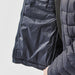 Women's Tundra Thermal Jacket - A navy blue women's puffer jacket with an unzipped interior pocket and quilted design. Features a logo on the sleeve.