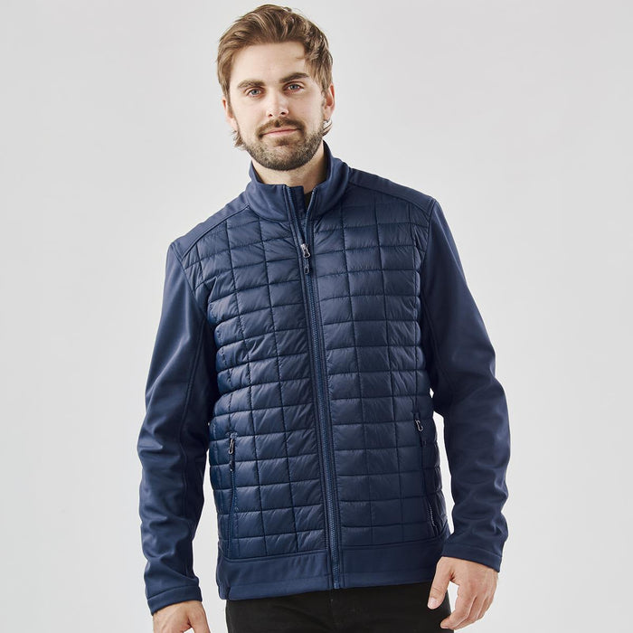 Men's Appalachian Thermal Softshell Jacket - A men's navy softshell jacket with a quilted front and a straight zip closure, featuring a logo on the chest.