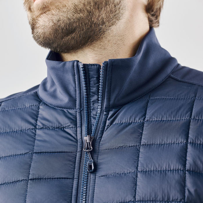 Men's Appalachian Thermal Softshell Jacket - A men's softshell jacket in navy blue with a high collar and quilted texture. Features a zippered front.