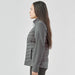 Women's Appalachian Thermal Softshell Jacket - A woman stands sideways wearing a grey Women's Appalachian Thermal Softshell Jacket. The jacket features a quilted design and a logo.