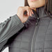 Women's Appalachian Thermal Softshell Jacket - A women's grey softshell jacket featuring a quilted design and a zippered front. It has a logo on the chest.