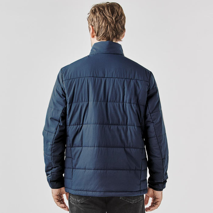Men's Sierra Thermal Jacket - A thermal puffer jacket in navy, featuring a quilted design and a high collar. It has a logo on the exterior.