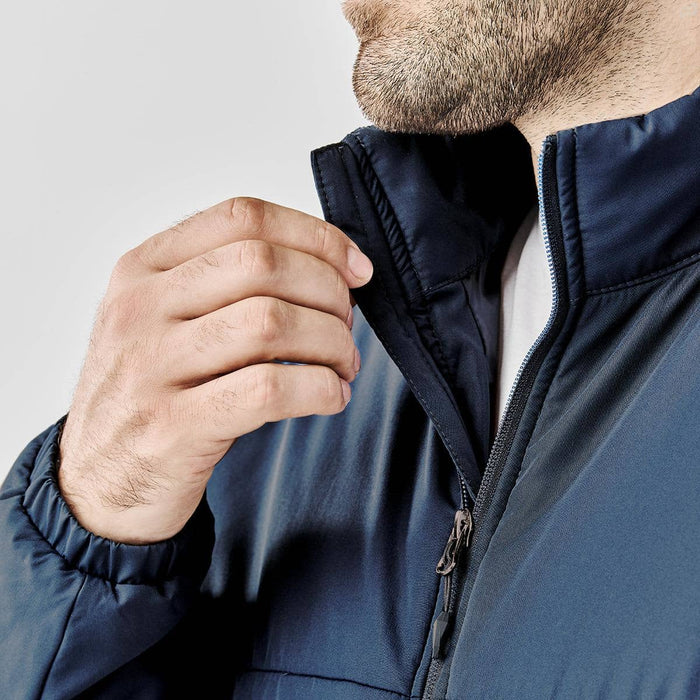 Men's Sierra Thermal Jacket - A close-up of a man wearing a navy blue Sierra Thermal Jacket, showcasing the collar and zipper detail.