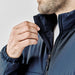 Men's Sierra Thermal Jacket - A close-up of a man wearing a navy blue Sierra Thermal Jacket, showcasing the collar and zipper detail.