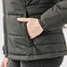 Women's Sierra Thermal Jacket - A women's dark green puffer jacket featuring a side pocket and quilted design. It has a fitted silhouette.