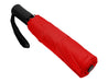 Como Fold-Up Umbrella - A red fold-up umbrella with a black handle and strap, closed and compact. It features a branding logo.