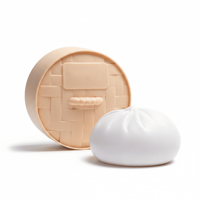Squishy Bun - A squishy toy shaped like a steamed bun, featuring a round, woven base and a white bun-like top.