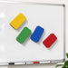 Magnetic Foam Whiteboard Eraser - Four magnetic foam whiteboard erasers in yellow, green, blue, and red are attached to a whiteboard.