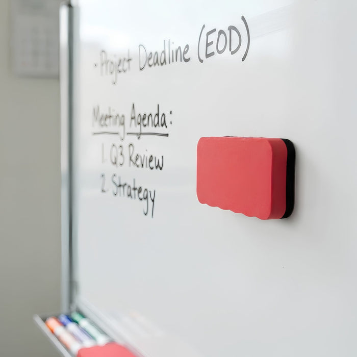 Magnetic Foam Whiteboard Eraser - A magnetic foam whiteboard eraser in red and black, positioned on a whiteboard beside written notes.