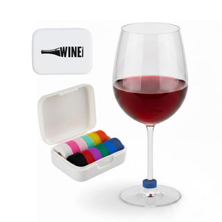 Wine Glass Marker - A wine glass filled with red wine beside a white case containing colourful wine glass markers.