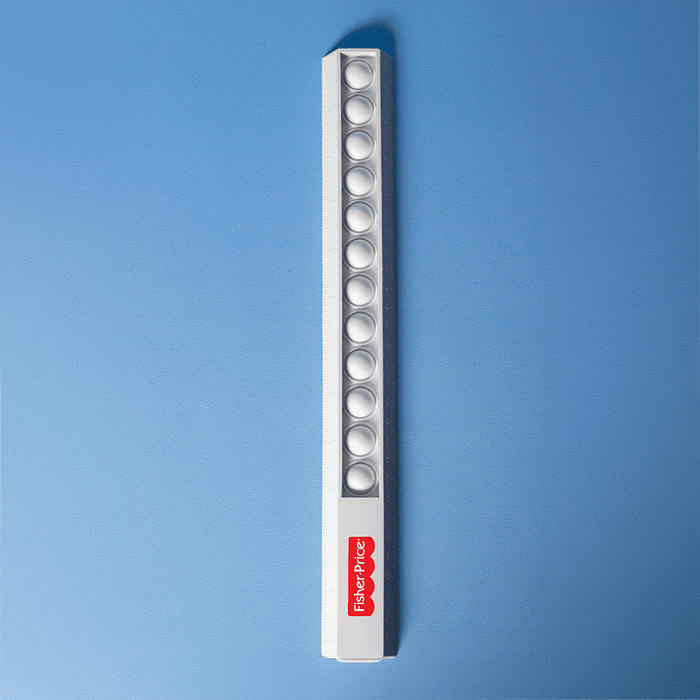 30cm Popper Ruler - A white popper ruler featuring multiple poppers along its length and a small logo.