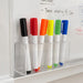 Bonack Whiteboard Marker - A display of seven Bonack whiteboard markers in various colours, including black, red, orange, yellow, green, and blue, stored in a clear holder.