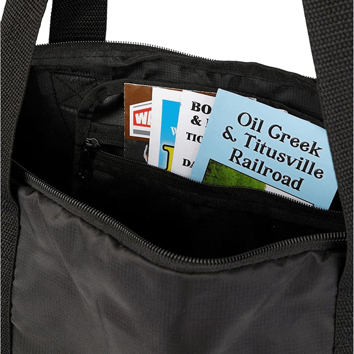 Wander & Roam Packable Travel Duffel Bag - A black duffle bag interior with various pamphlets and brochures visible inside.