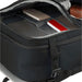 Wander & Roam Travel Backpack - An open black travel backpack displaying multiple compartments containing notebooks and a small device.