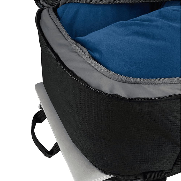 Wander & Roam Travel Backpack - A black travel backpack interior showing a blue cushioned compartment and a silver laptop underneath.